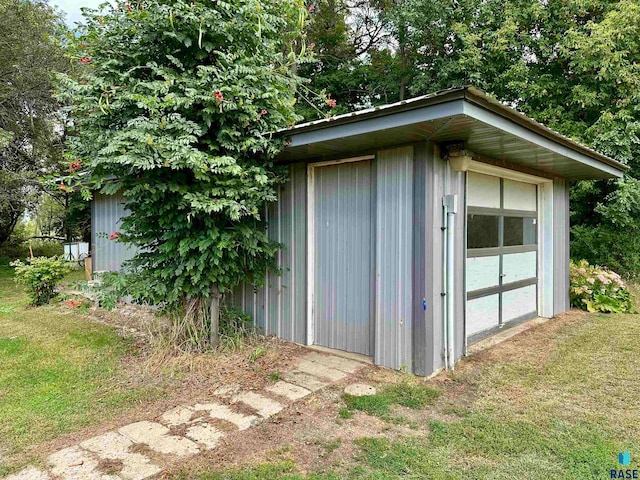 view of outbuilding with a lawn