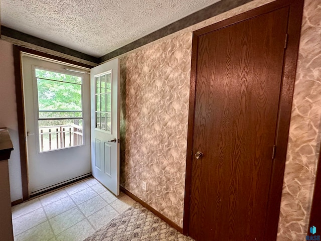 doorway featuring a textured ceiling