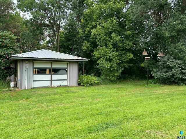 exterior space with a yard and a garage