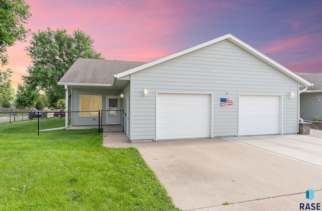 ranch-style home with driveway, roof with shingles, an attached garage, fence, and a front yard