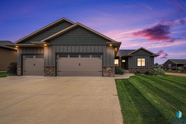 view of front facade with a garage and a lawn