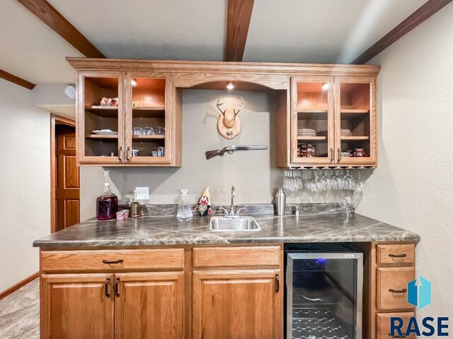 bar with beam ceiling, beverage cooler, sink, and crown molding