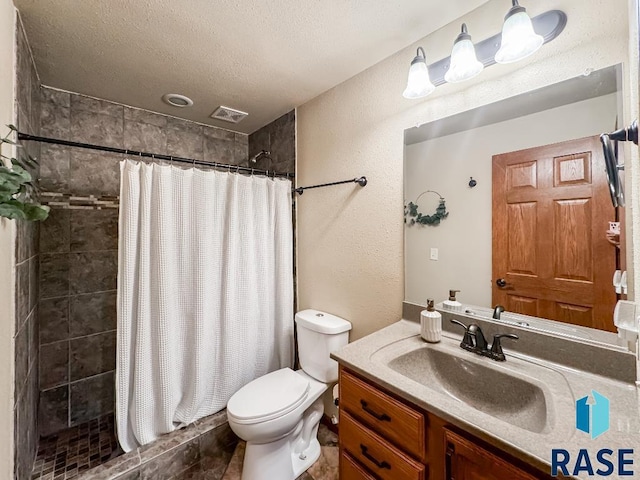 bathroom with a textured ceiling, toilet, vanity, and a shower with curtain