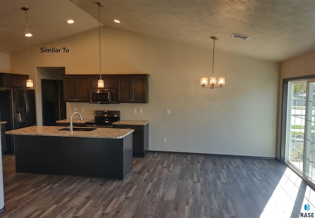 kitchen with appliances with stainless steel finishes, a center island with sink, dark brown cabinetry, and sink