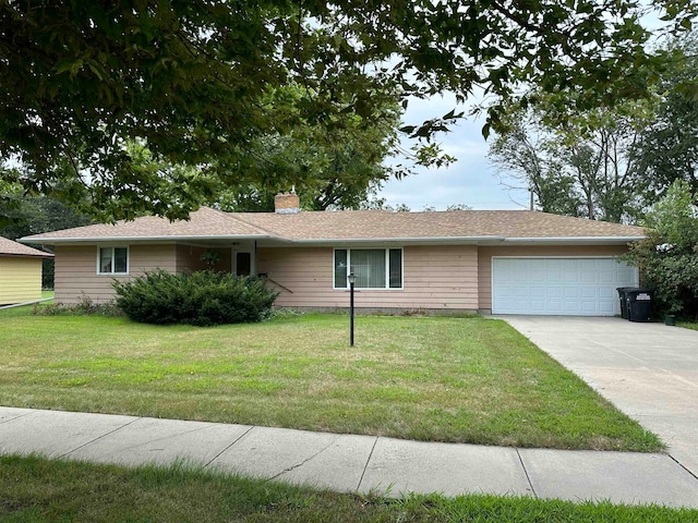 ranch-style house with a front yard and a garage