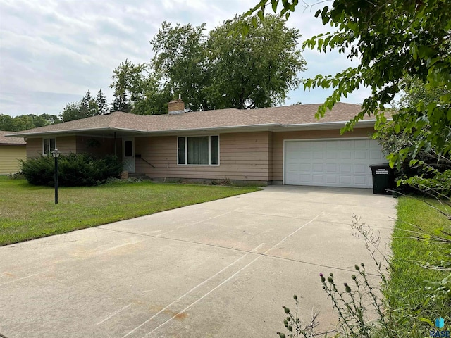 single story home with a front yard and a garage