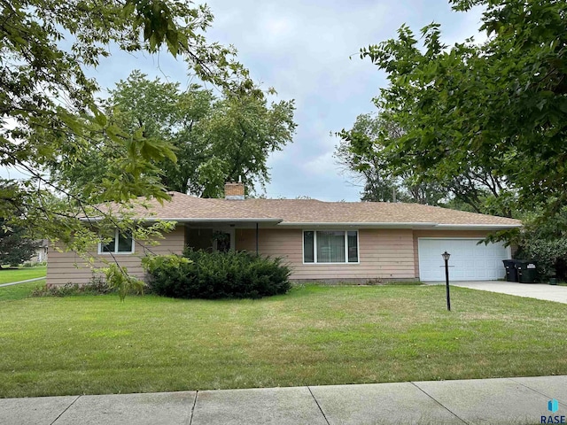 ranch-style home with a front lawn and a garage