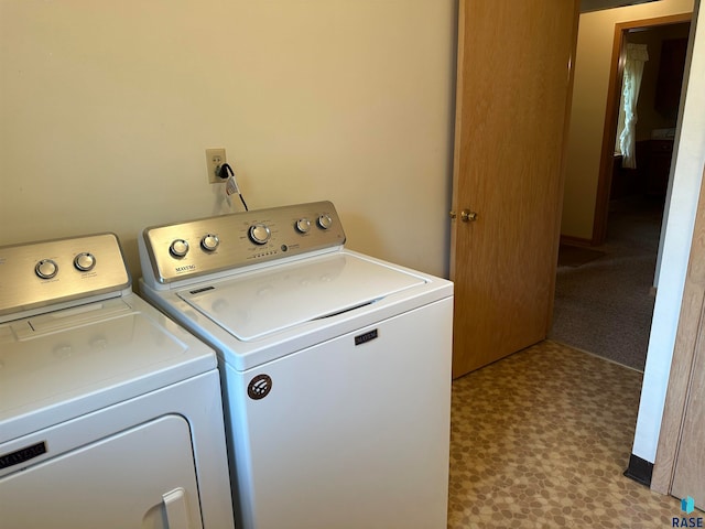 clothes washing area featuring washing machine and dryer and light tile patterned flooring