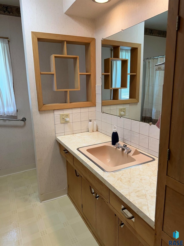 bathroom with tile patterned floors, tasteful backsplash, and vanity