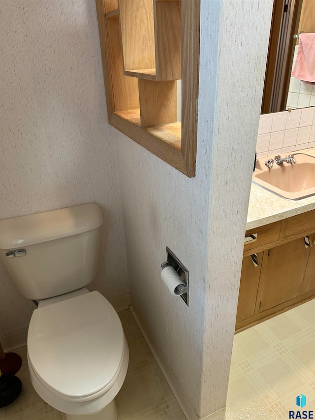 bathroom with backsplash, toilet, tile patterned flooring, and vanity