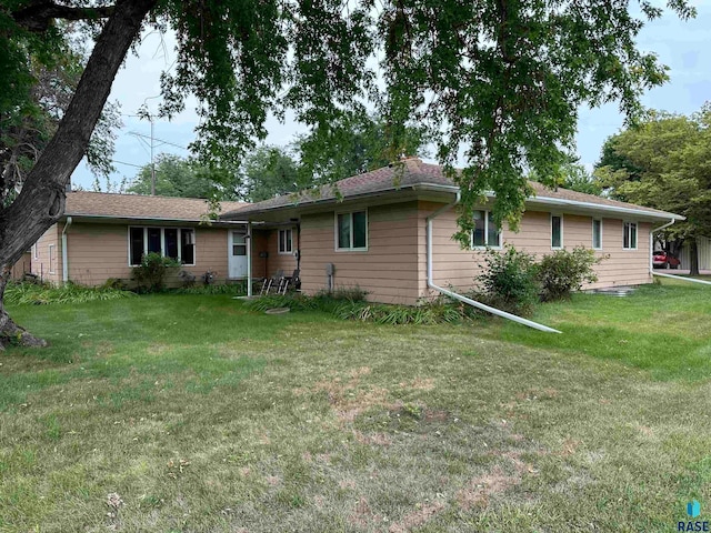 rear view of house with a yard