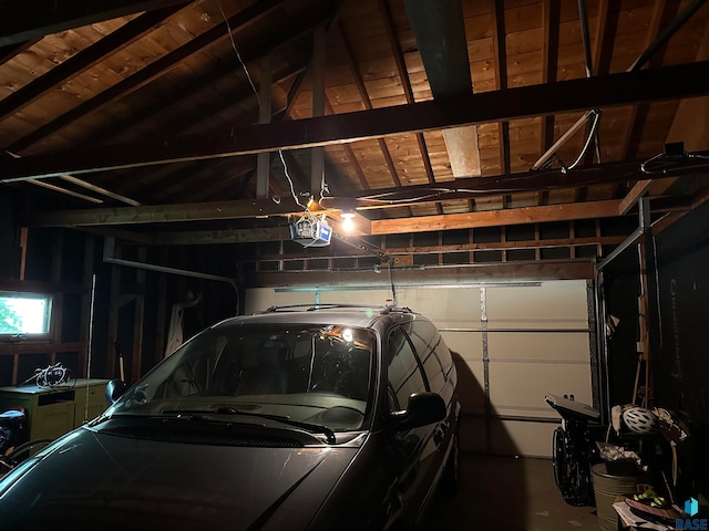 garage featuring wood ceiling and a garage door opener