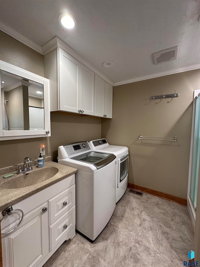 clothes washing area featuring light tile patterned flooring, sink, cabinets, crown molding, and independent washer and dryer