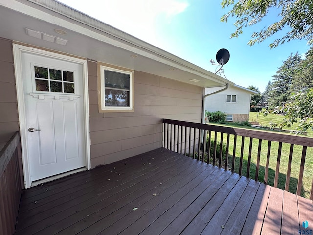 wooden deck with a lawn