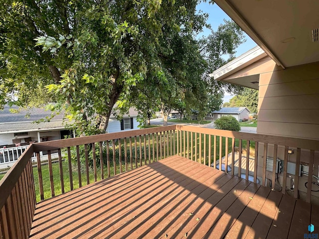 wooden terrace featuring a yard