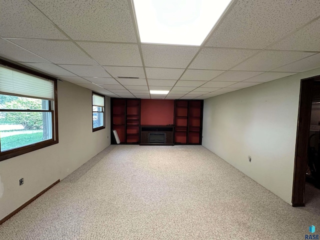 spare room with carpet flooring and a drop ceiling