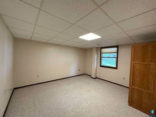 interior space with a drop ceiling and light carpet