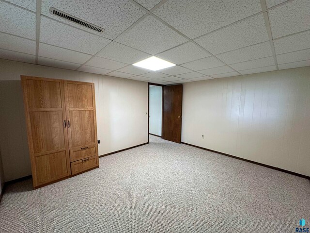 interior space with light colored carpet and a drop ceiling