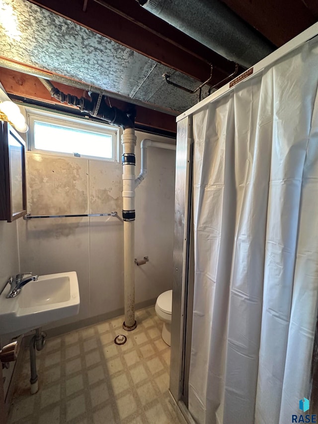 bathroom with sink, toilet, a shower with shower curtain, and tile patterned floors