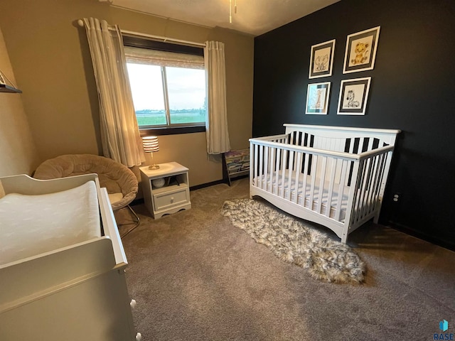 carpeted bedroom featuring a crib