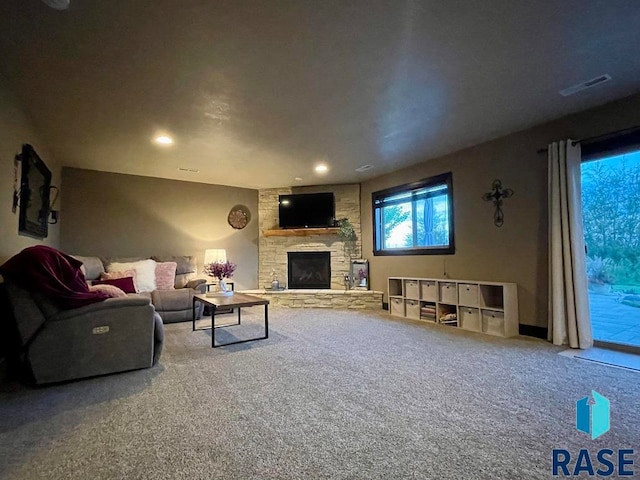 living room with carpet and a fireplace