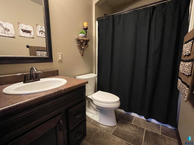 bathroom with tile patterned floors, toilet, and vanity