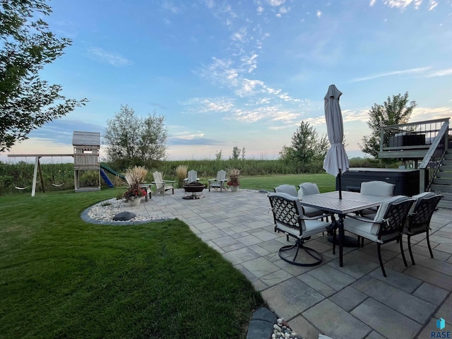 view of patio featuring a playground and a fire pit