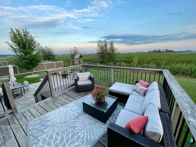 deck at dusk with outdoor lounge area