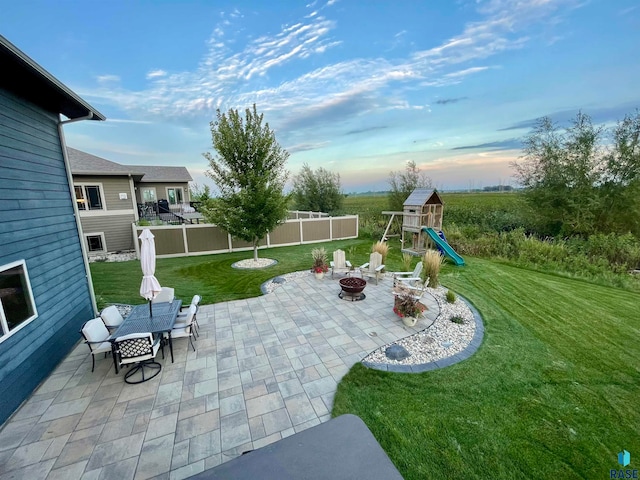 exterior space with a patio, a fire pit, and a playground