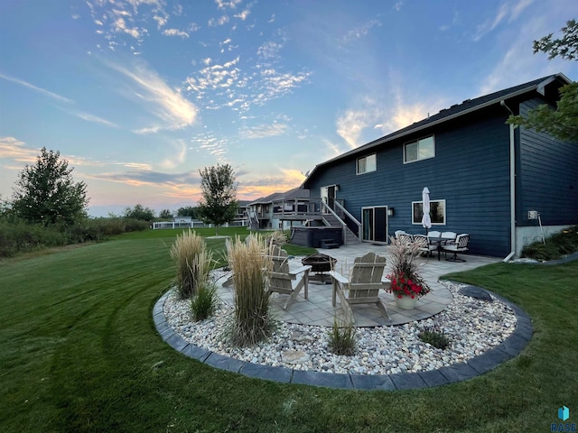 yard at dusk with a patio area