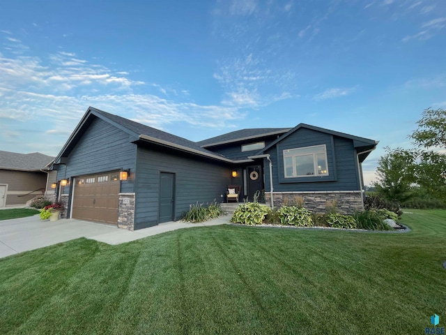 view of front of property with a garage and a front yard