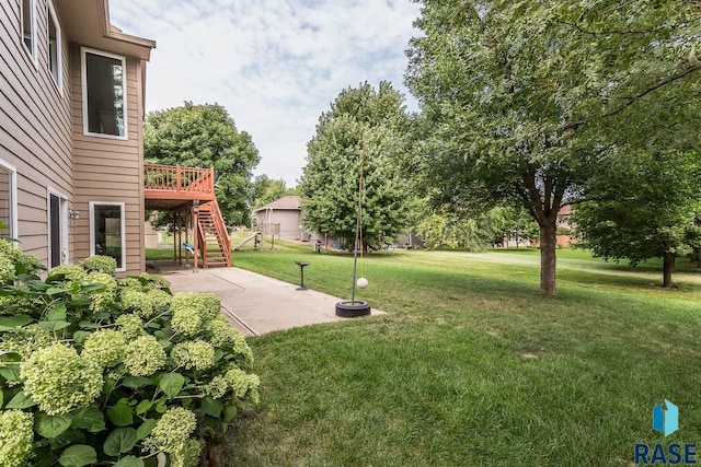 view of yard featuring a patio and a deck