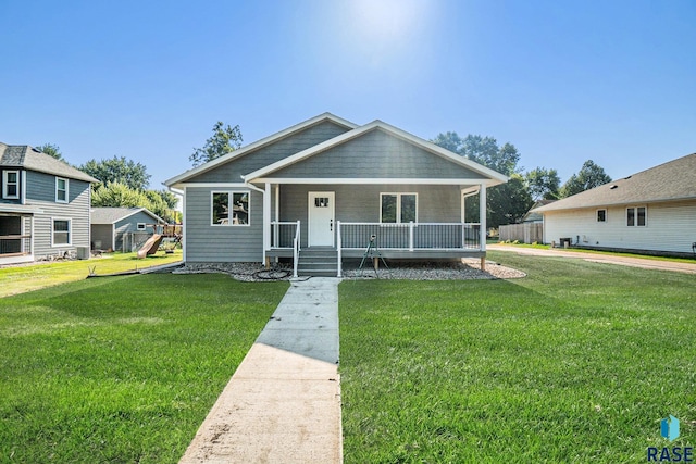 bungalow with a porch and a front lawn