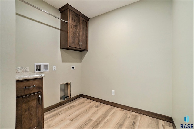 washroom with light wood-type flooring, hookup for an electric dryer, washer hookup, and cabinets