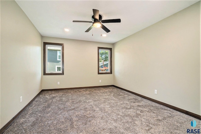 unfurnished room with a ceiling fan, carpet flooring, and baseboards