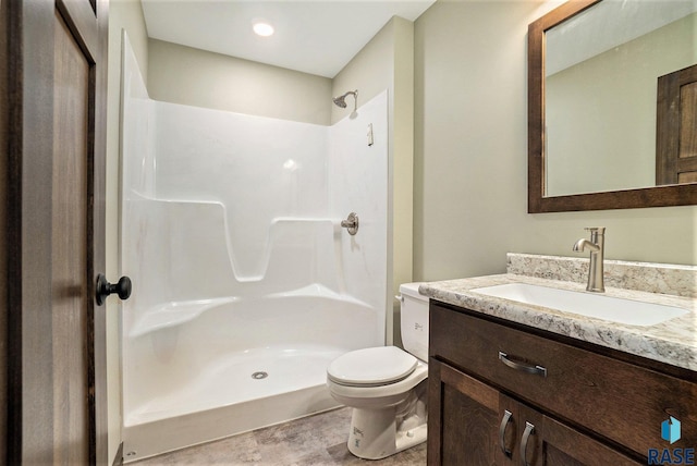 full bathroom featuring vanity, toilet, and walk in shower