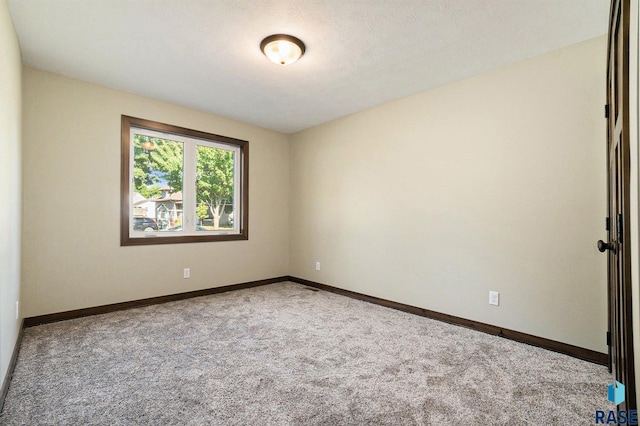 spare room with carpet floors and baseboards