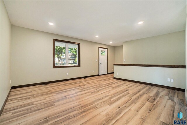 unfurnished room with light wood-type flooring