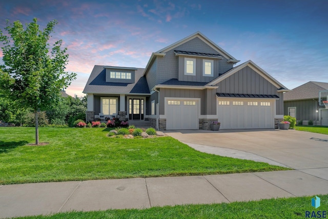 craftsman inspired home with concrete driveway, stone siding, covered porch, board and batten siding, and a front yard