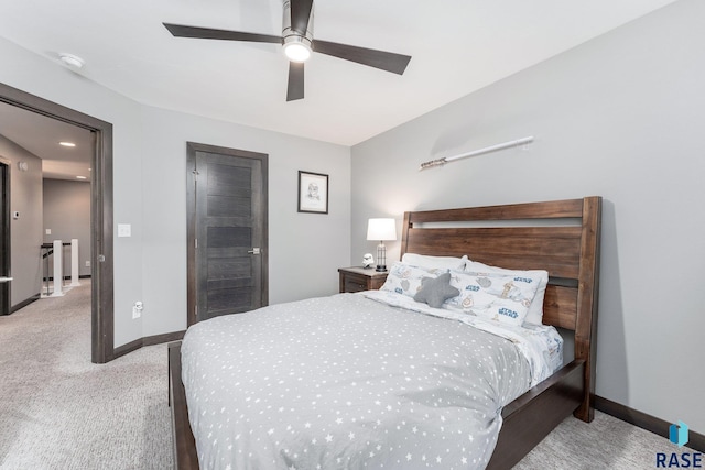 bedroom with light carpet, ceiling fan, and baseboards