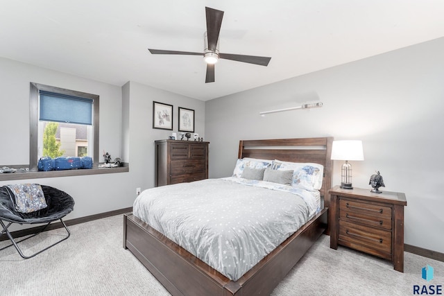 bedroom with light carpet, a ceiling fan, and baseboards