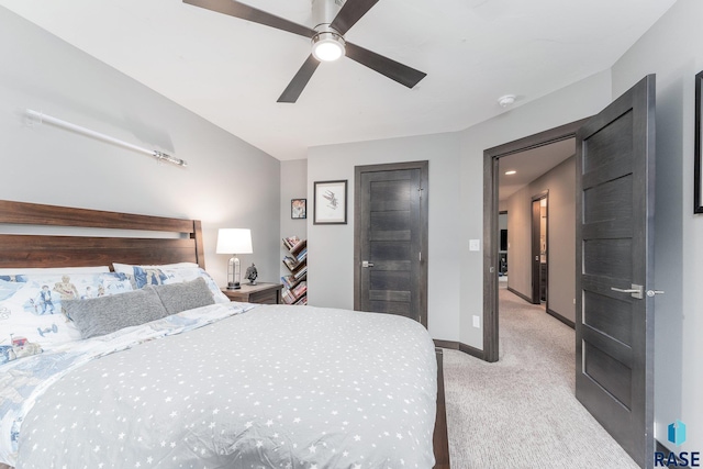 bedroom with baseboards, a ceiling fan, and light colored carpet