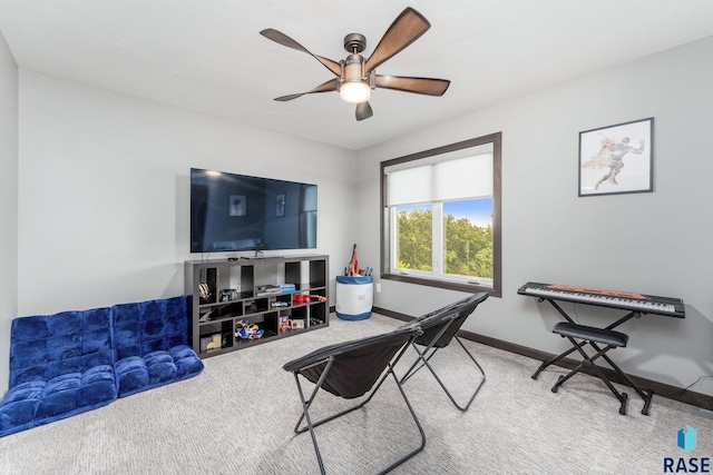 interior space featuring a ceiling fan, carpet flooring, and baseboards