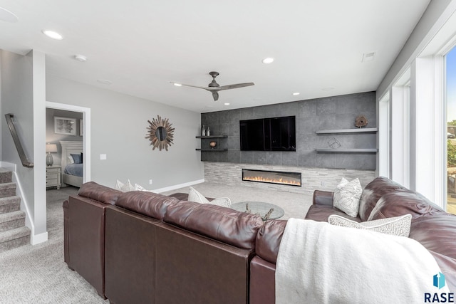 living room with baseboards, light colored carpet, stairway, a fireplace, and recessed lighting