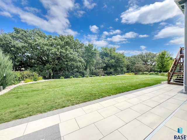 view of yard with stairway and a patio area