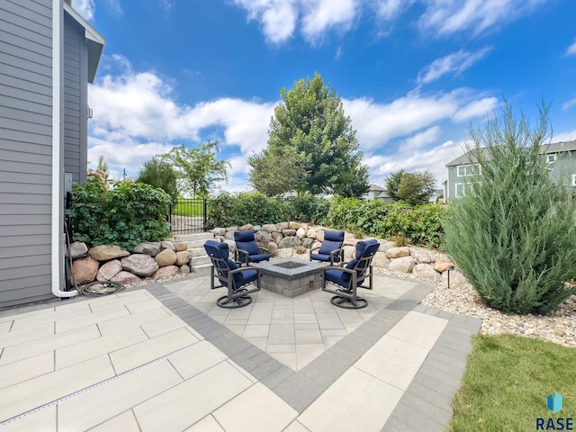 view of patio / terrace featuring an outdoor fire pit and fence