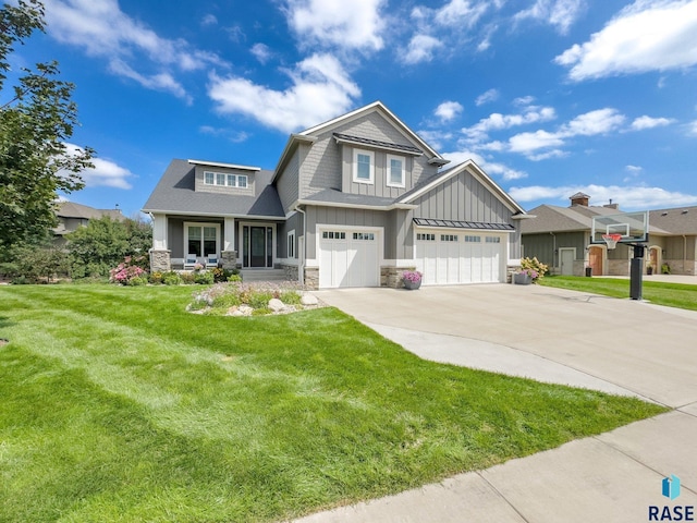 craftsman inspired home with driveway, stone siding, a porch, a front lawn, and board and batten siding