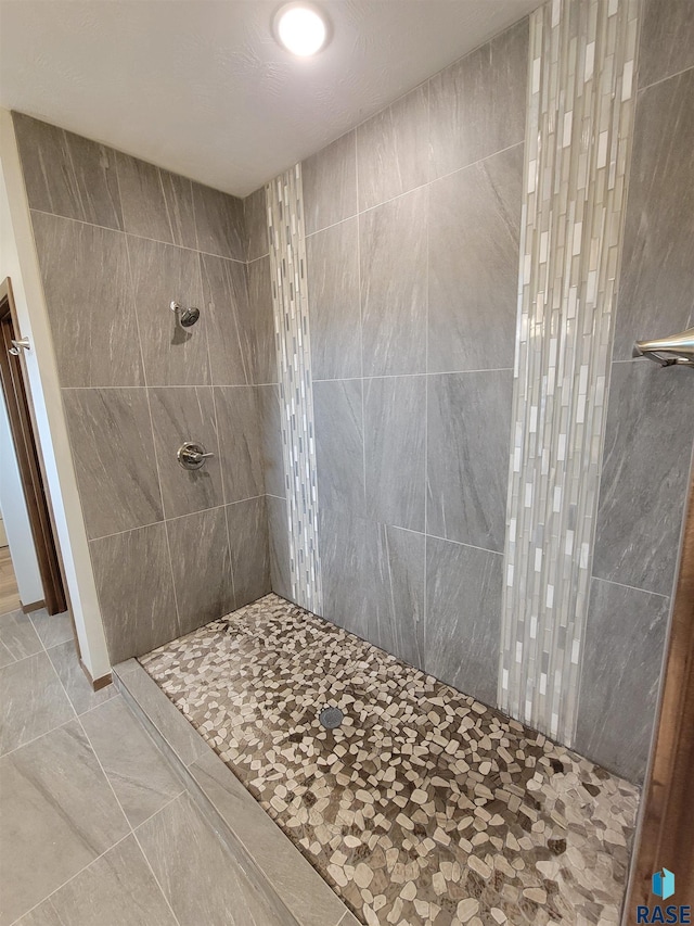 full bath featuring a tile shower