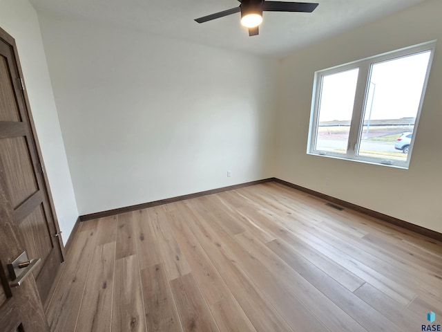8106 E Norway Pines Trl, Sioux Falls, SD 57110 - empty room featuring a ceiling fan, baseboards, light wood finished floors, and visible vents