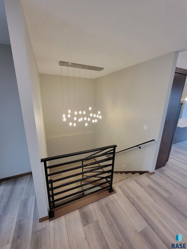 stairway featuring baseboards and wood finished floors